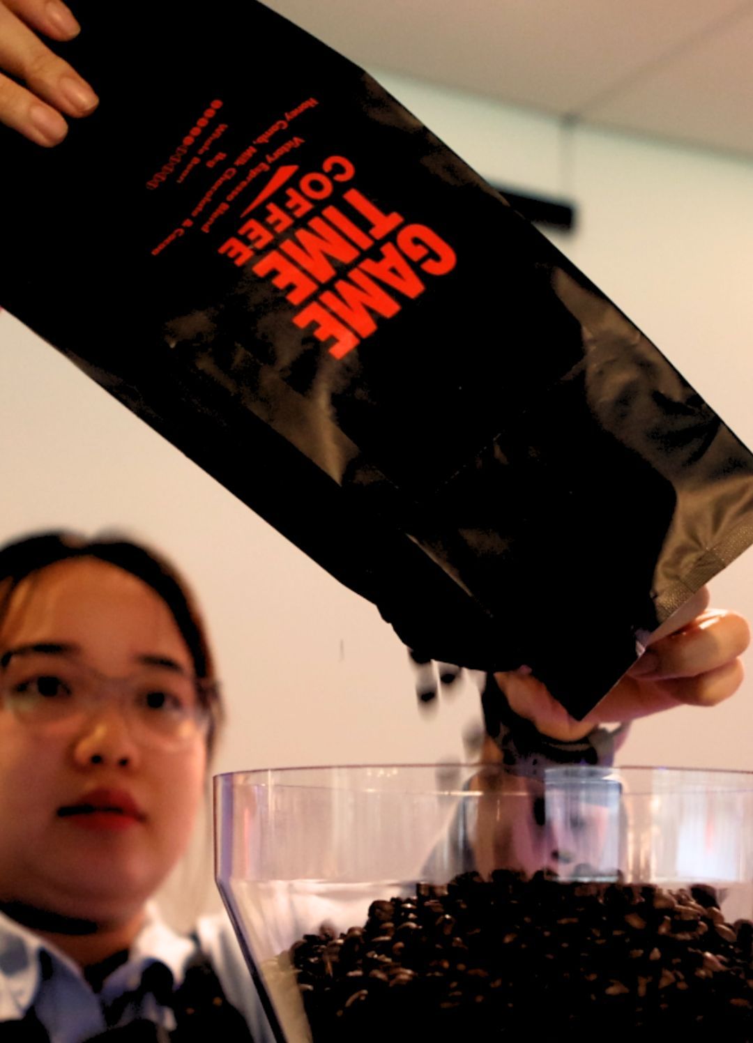 Game Time Coffee beans pouring from the bag into the grinder