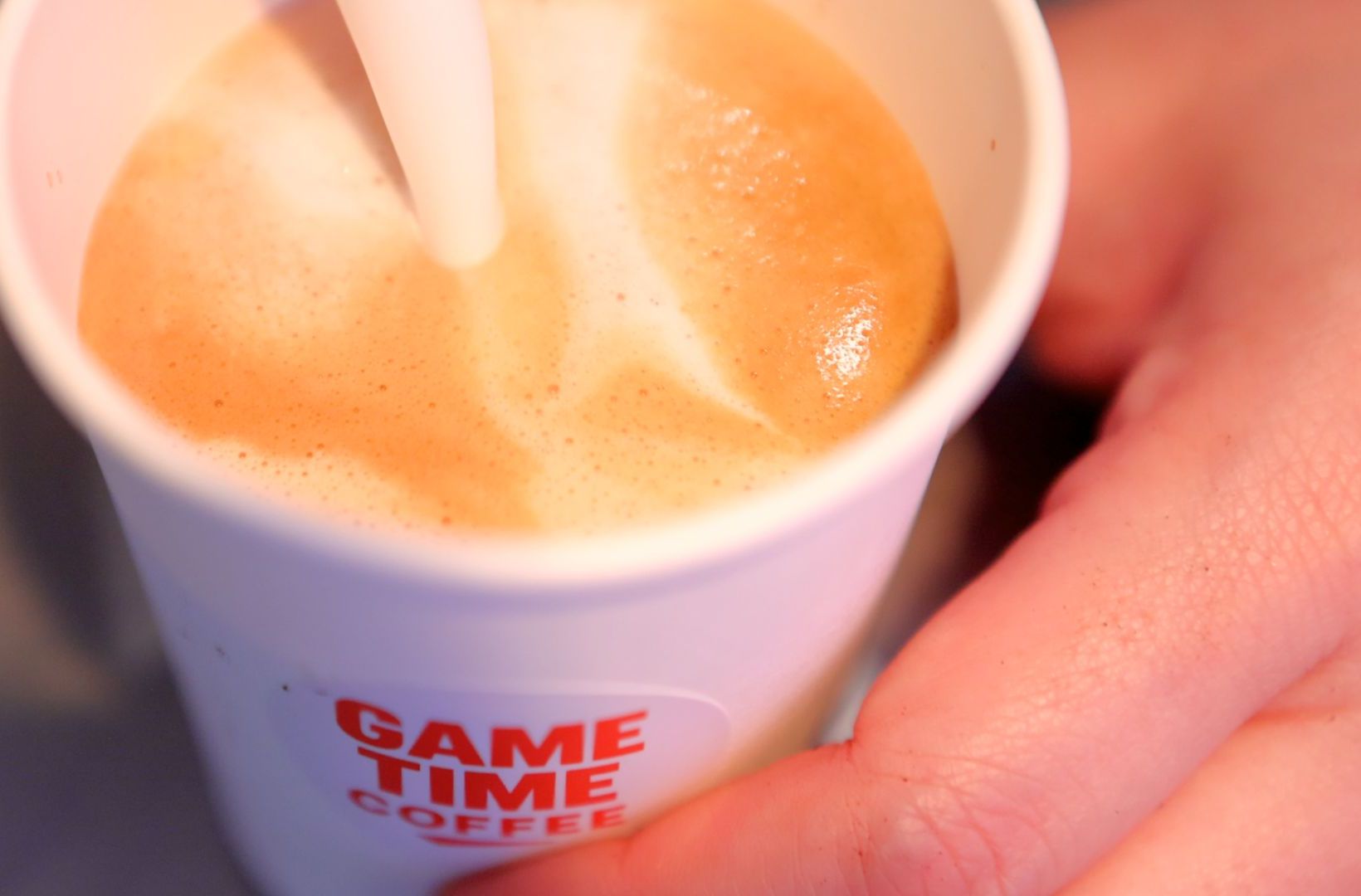 Close-up of a latte in a Game Time Coffee cup